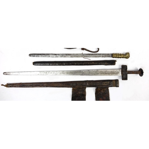 260 - Three Asian and Middle Eastern swords and knifes including a Tuareg, the largest 90cm in length