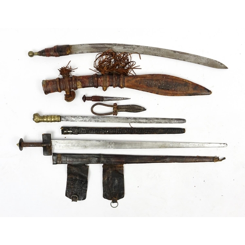 260 - Three Asian and Middle Eastern swords and knifes including a Tuareg, the largest 90cm in length