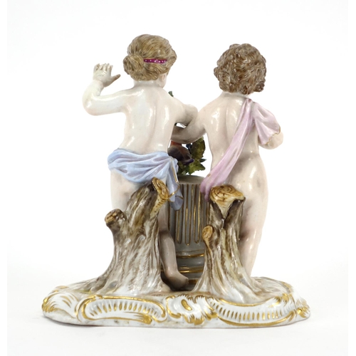 484 - 19th century Meissen hand painted porcelain figure group of two putti holding a wreath with a bird, ... 