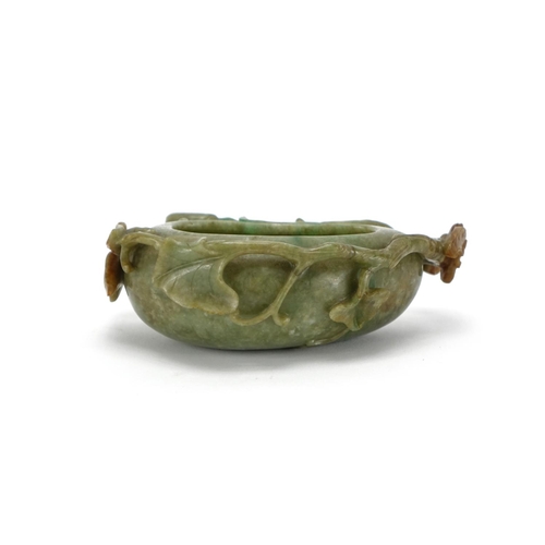 393 - Chinese green and russet jade naturalistic brush washer, carved with a bat and butterfly, 14cm wide