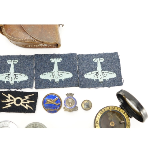219 - Military interest compass with tan leather case together with a group of cloth patches and badges in... 