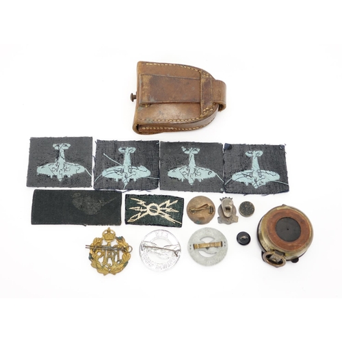 219 - Military interest compass with tan leather case together with a group of cloth patches and badges in... 
