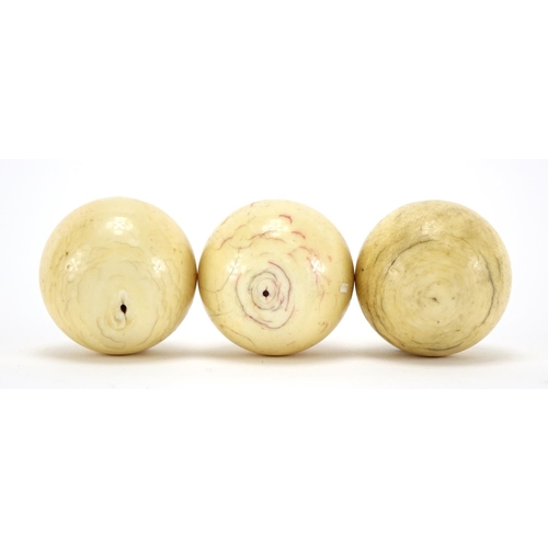 8 - Three 19th century turned ivory billiard balls, each approximately 5.3cm in diameter