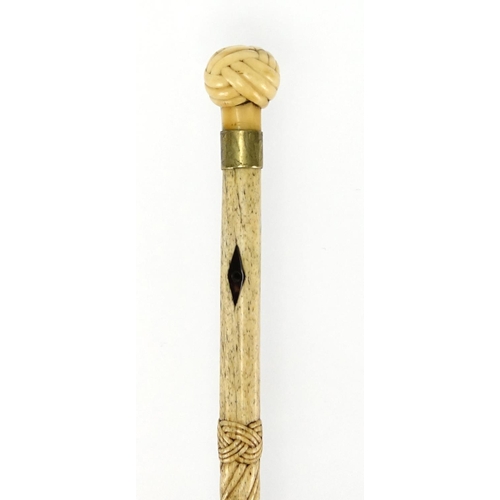 71 - Antique carved whale bone walking stick with carved ivory Turk's head knop, 78cm in length