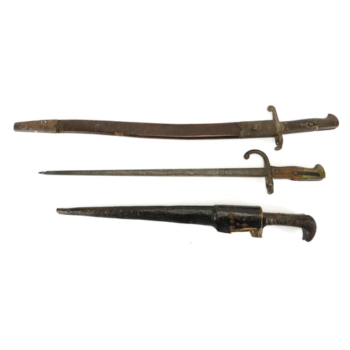 256 - Two Military interest long bayonets and an Afghan dagger with scabbard, the largest 74cm in length