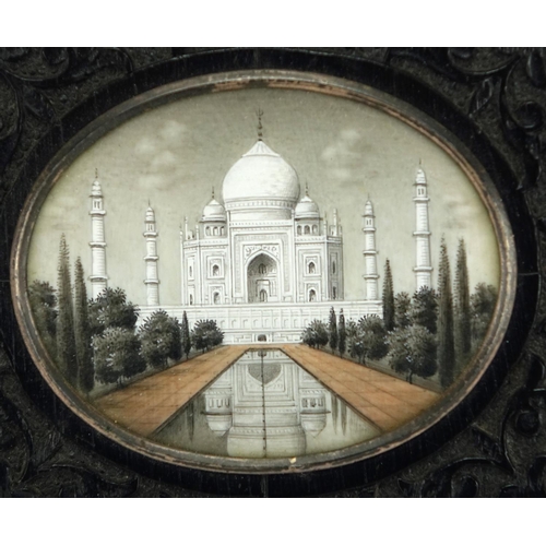 459 - Indian oval miniature finely hand painted with The Taj Mahal, housed in an ebony easel frame carved ... 