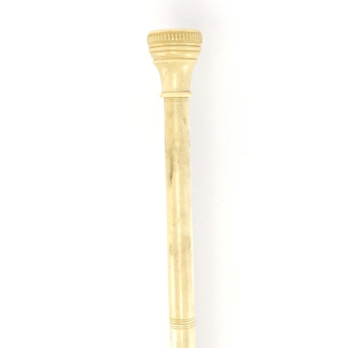 74 - 19th century turned and carved ivory walking stick, the pommel with inset compass, 91cm in length