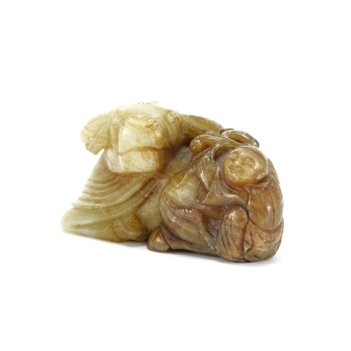 392 - Green and russet jade carving of a buffalo and boy, 12cm high