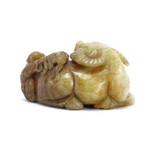 392 - Green and russet jade carving of a buffalo and boy, 12cm high