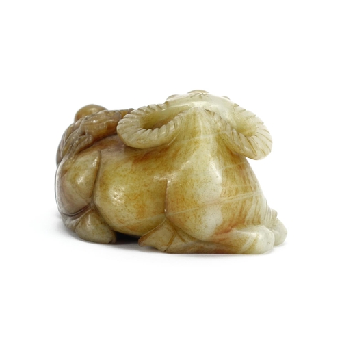 392 - Green and russet jade carving of a buffalo and boy, 12cm high