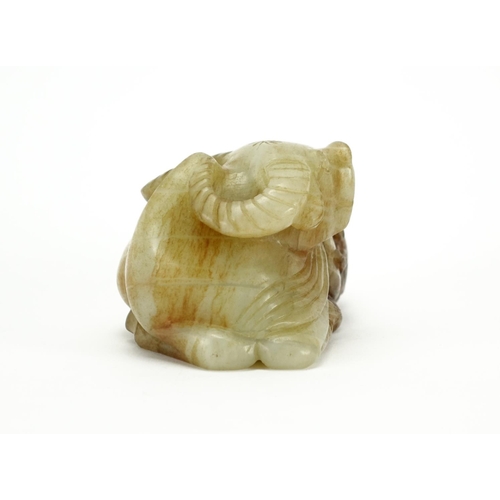 392 - Green and russet jade carving of a buffalo and boy, 12cm high