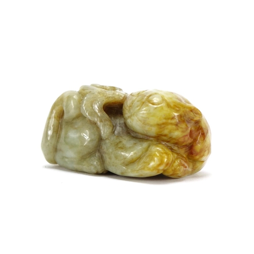 391 - Chinese green and russet jade carving of a mythical character, 6.5cm wide