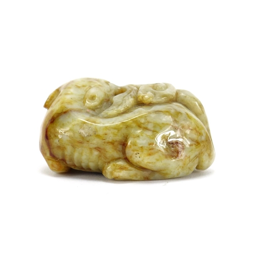 391 - Chinese green and russet jade carving of a mythical character, 6.5cm wide