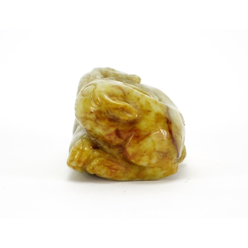 391 - Chinese green and russet jade carving of a mythical character, 6.5cm wide