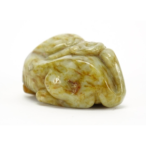 391 - Chinese green and russet jade carving of a mythical character, 6.5cm wide