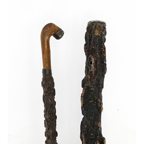82 - Two silver mounted cork walking sticks, the largest 91.5cm in length