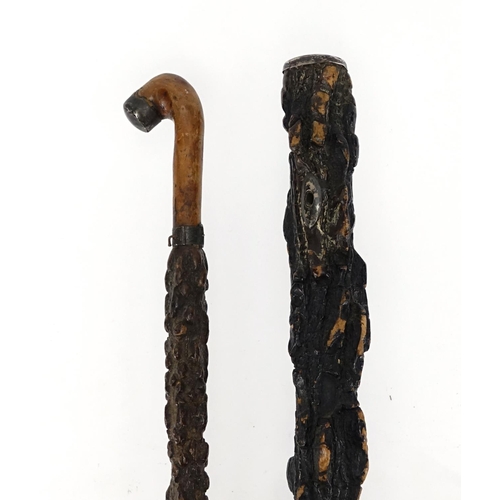 82 - Two silver mounted cork walking sticks, the largest 91.5cm in length