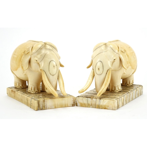 462 - Pair of carved ivory elephants raised on rectangular elephant teeth bases, each 13cm wide