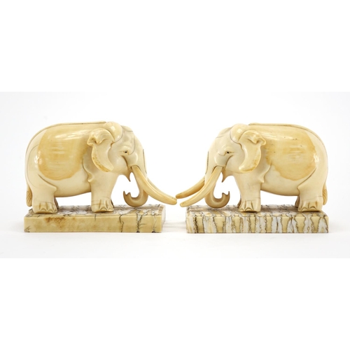 462 - Pair of carved ivory elephants raised on rectangular elephant teeth bases, each 13cm wide