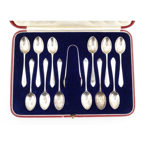 663 - Set of twelve silver teaspoons and sugar tongs, by Hamilton & Inches, Edinburgh 1934, housed in a ve... 