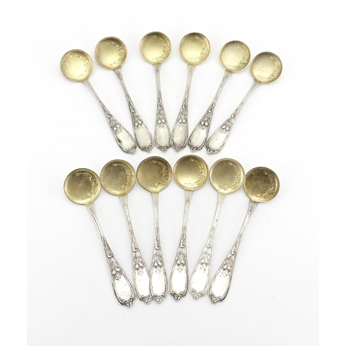 657 - Set of twelve Russian silver ice cream spoons, the stems with stylised flowers, each with impressed ... 