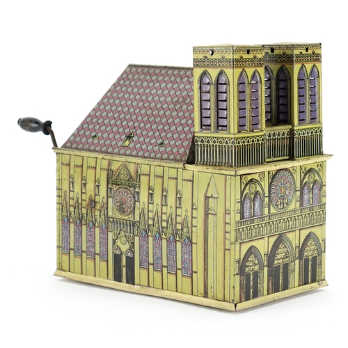 126 - German tin plate wind up music box in the form of a cathedral, 17cm high