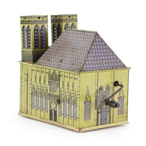 126 - German tin plate wind up music box in the form of a cathedral, 17cm high