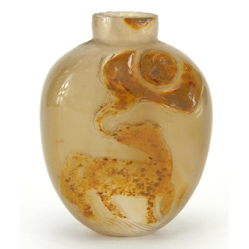 387 - Chinese agate snuff bottle carved with a mythical animal, 5.1cm high