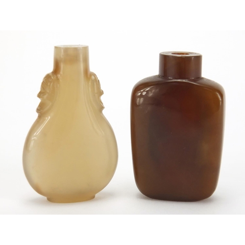 388 - Two Chinese hardstone snuff bottles, one with animalia handles the other carved with a Daoist emblem... 