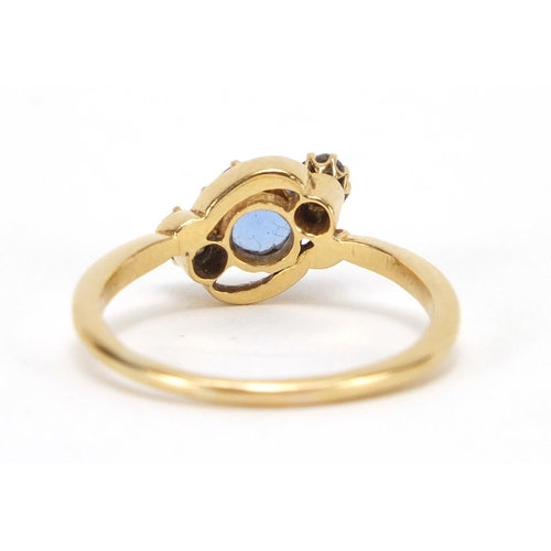 735 - 18ct gold blue stone and diamond crossover ring, size P, approximate weight 3.4g