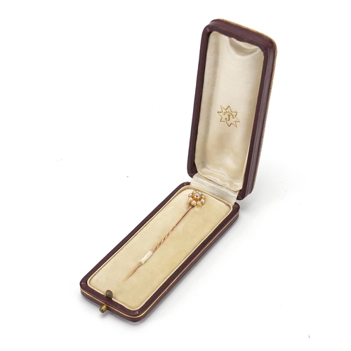 750 - Unmarked diamond and seed pearl tie pin, housed in a Junghans tooled leather box, 7cm in length, app... 