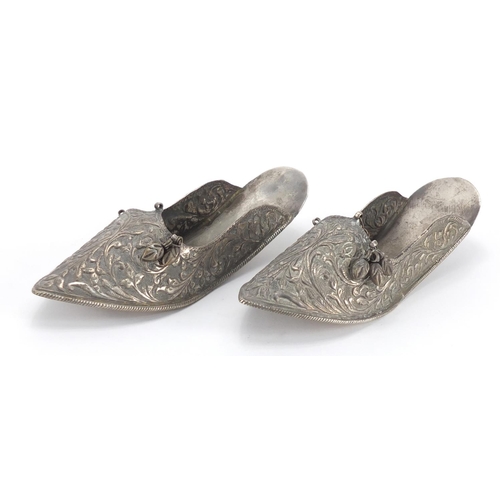 465 - Pair of Middle Eastern unmarked silver slippers, embossed with foliate motifs, each 17cm in length, ... 