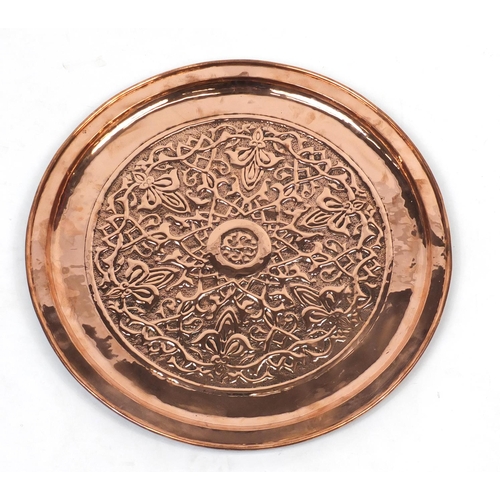 568 - Large Arts & Crafts copper charger by Keswick, embossed with stylised floral motif, impressed marks ... 