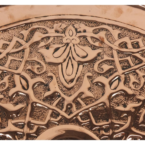 568 - Large Arts & Crafts copper charger by Keswick, embossed with stylised floral motif, impressed marks ... 