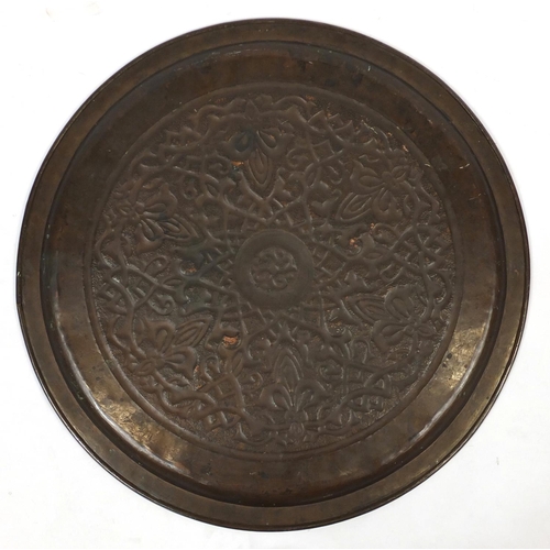 568 - Large Arts & Crafts copper charger by Keswick, embossed with stylised floral motif, impressed marks ... 