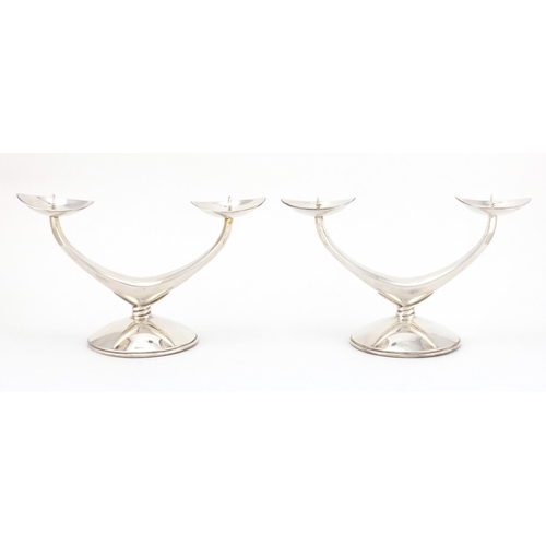 645 - Pair of Danish silver two branch candelabra, each stamped 835 WTB, 11cm high x 19cm wide, approximat... 