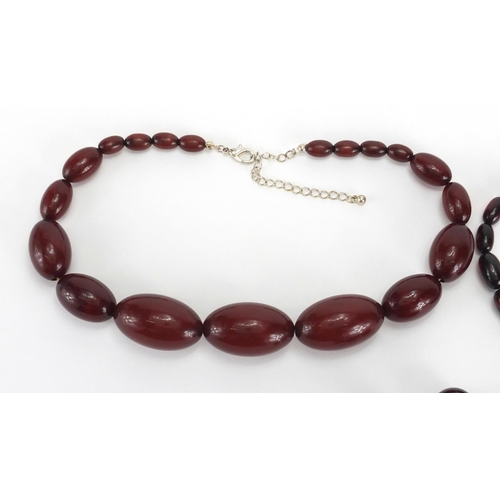 813 - Two amber coloured bead necklaces and a selection of loose beads, the largest bead approximately 3.5... 