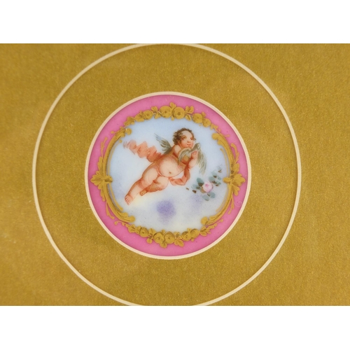 2157 - Pair of 19th century circular porcelain panels in the style of Sèvres, hand painted with putti, each... 