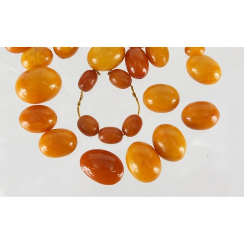 803 - Butterscotch amber coloured beads, the largest 2.5cm in length, approximate weight 68.0g