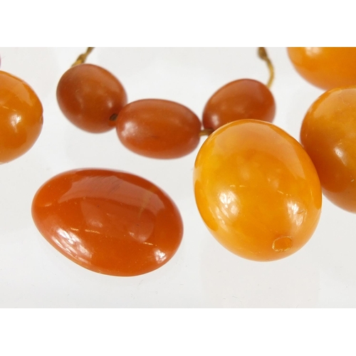 803 - Butterscotch amber coloured beads, the largest 2.5cm in length, approximate weight 68.0g