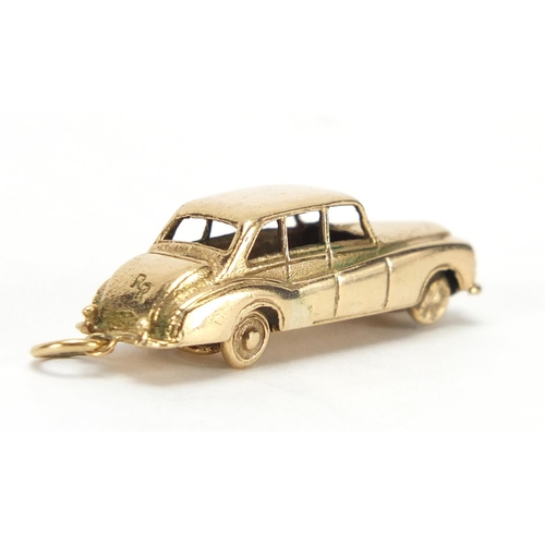 2430 - Large 9ct gold saloon car charm, 4cm in length, approximate weight 11.5g