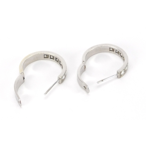 667 - Pair of unmarked white metal diamond hoop earrings, 2.4cm in diameter, approximate weight 8.3g