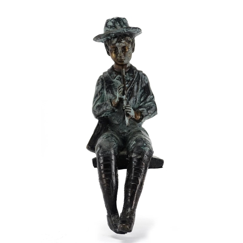 2135 - Bronzed study of a boy seated playing a flute, 34.5cm high
