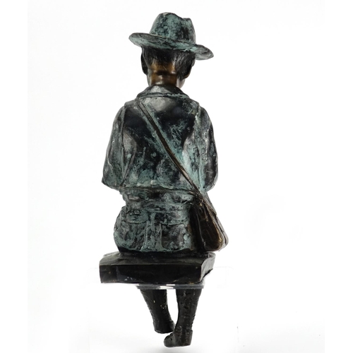 2135 - Bronzed study of a boy seated playing a flute, 34.5cm high