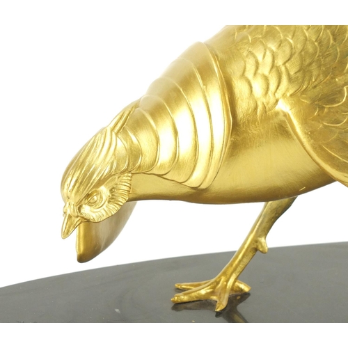 2116 - Large gilt painted Chinese pheasant raised on an oval black slate base, 55cm high