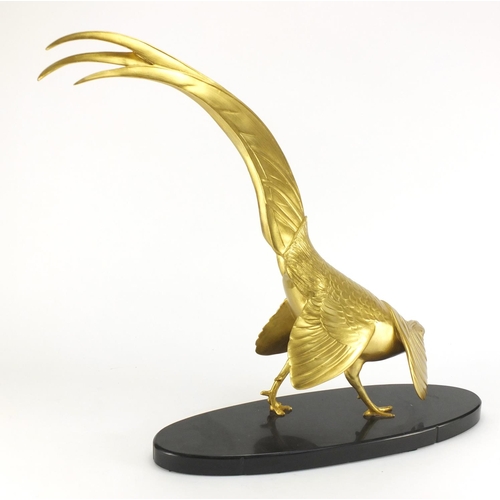 2116 - Large gilt painted Chinese pheasant raised on an oval black slate base, 55cm high