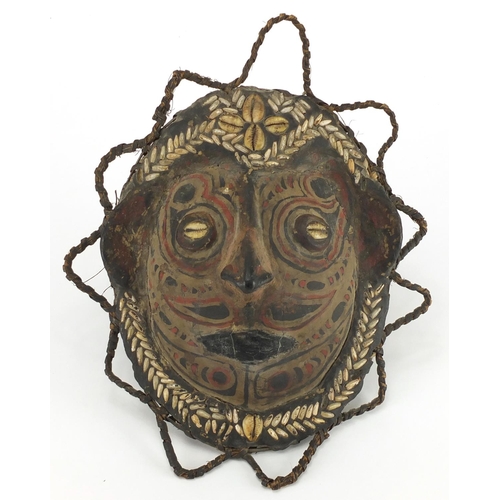 452 - Papua new Guinea Sepik River turtle shell mask, hand painted and inset with cowrie shells, 32cm x 27... 