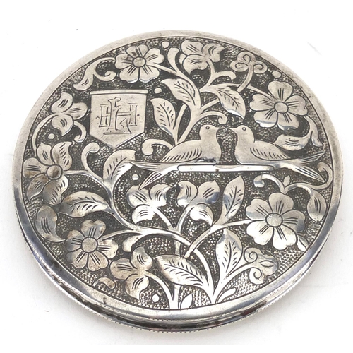 2388 - Continental circular silver compact, the hinged lid embossed with birds amongst flowers, impressed m... 