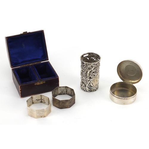 2392 - Silver items, two octagonal napkin rings, circular trinket and bottle case embossed with cherubs, va... 