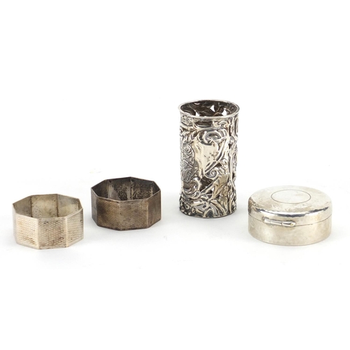 2392 - Silver items, two octagonal napkin rings, circular trinket and bottle case embossed with cherubs, va... 